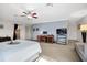 Main bedroom with carpeted floor, built-in desk and large TV at 2781 Westchester Dr S, Clearwater, FL 33761