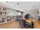 Home office with built-in shelves and hardwood floors at 2781 Westchester Dr S, Clearwater, FL 33761