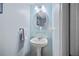 Small powder room with pedestal sink and blue tile at 2781 Westchester Dr S, Clearwater, FL 33761