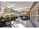 Screened patio with seating area and access to the pool at 2781 Westchester Dr S, Clearwater, FL 33761