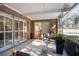 Covered porch with sliding glass doors and a bench at 2781 Westchester Dr S, Clearwater, FL 33761