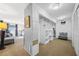 Large walk-in closet with built-in shelving and sitting area at 2781 Westchester Dr S, Clearwater, FL 33761