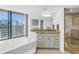 Spa-like bathroom with granite vanity, soaking tub, and glass shower at 2795 Kipps Colony S Dr # 305, St Petersburg, FL 33707