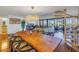 Spacious dining area with a long wooden table and hardwood floors at 2795 Kipps Colony S Dr # 305, St Petersburg, FL 33707
