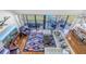 Bright living room, hardwood floors, balcony access at 2795 Kipps Colony S Dr # 305, St Petersburg, FL 33707
