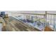 Loft area with hardwood flooring and views of the living room and balcony at 2795 Kipps Colony S Dr # 305, St Petersburg, FL 33707