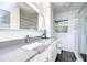 Updated bathroom with gray countertop, white cabinets and walk-in shower at 300 Venetian Dr # 7, Clearwater, FL 33755