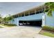 Building exterior features light blue facade and covered parking at 300 Venetian Dr # 7, Clearwater, FL 33755