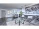 Open living room with modern gray sectional sofa and kitchen view at 300 Venetian Dr # 7, Clearwater, FL 33755