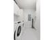 Modern laundry room with Whirlpool washer and dryer, and ample cabinetry at 301 1St Street S # 1204, St Petersburg, FL 33701