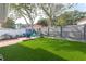 Artificial turf backyard with a patio and fire pit area at 3116 Winchester Dr, Dunedin, FL 34698