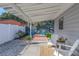Relaxing backyard patio with seating, fire pit, and artificial turf at 3116 Winchester Dr, Dunedin, FL 34698