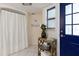 Clean bathroom with shower, and a blue door at 3116 Winchester Dr, Dunedin, FL 34698