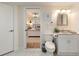 Bright bathroom with white vanity, toilet and view of bedroom at 3116 Winchester Dr, Dunedin, FL 34698