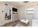 Bedroom with dresser and view of bathroom entrance at 3116 Winchester Dr, Dunedin, FL 34698