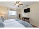 Guest bedroom with twin beds, a workspace, and a large TV at 3116 Winchester Dr, Dunedin, FL 34698