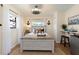 Cozy bedroom with a light-colored bed frame and nautical decor at 3116 Winchester Dr, Dunedin, FL 34698