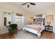 Bedroom with king-size bed, green chair and hardwood floors at 3116 Winchester Dr, Dunedin, FL 34698