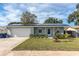 Newly renovated home with solar panels and a well-manicured lawn at 3116 Winchester Dr, Dunedin, FL 34698