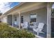 Inviting front porch with comfy chairs, perfect for relaxing at 3116 Winchester Dr, Dunedin, FL 34698