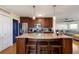 Open concept kitchen with island and seating, overlooking living room at 3116 Winchester Dr, Dunedin, FL 34698