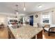 Kitchen island with granite countertop and seating for four at 3116 Winchester Dr, Dunedin, FL 34698
