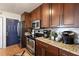 Well-equipped kitchen with dark wood cabinets and granite counters at 3116 Winchester Dr, Dunedin, FL 34698