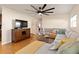 Living area featuring an L-shaped sofa and TV stand at 3116 Winchester Dr, Dunedin, FL 34698