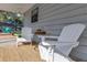 Cozy patio area with white Adirondack chairs and a side table at 3116 Winchester Dr, Dunedin, FL 34698