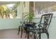 Relaxing front porch with two ornate metal chairs and potted plants at 3501 70Th N Way, St Petersburg, FL 33710