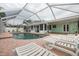 Relaxing pool area with lounge chairs and screened enclosure at 3501 70Th N Way, St Petersburg, FL 33710