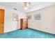 Bedroom with teal carpet, dresser, and ceiling fan at 4013 Lexington Ct, Largo, FL 33771