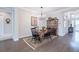 Elegant dining room with a wooden table, chandelier, and hardwood floors at 4840 Grand Banks Dr, Wimauma, FL 33598