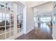 Hardwood floor hallway with french doors leading to an office at 4840 Grand Banks Dr, Wimauma, FL 33598