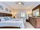 Main bedroom with king-size bed and dark brown dresser at 4909 Willow Ridge Ter, Valrico, FL 33596