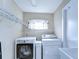 Laundry room with washer, dryer, and ample shelving at 4909 Willow Ridge Ter, Valrico, FL 33596