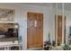 Interior entryway with a wooden door and mirrors at 4918 Woodland Dr, St Petersburg, FL 33708