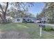 House exterior with a large front yard and American flag at 4918 Woodland Dr, St Petersburg, FL 33708