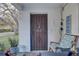 Front entrance with a security door and seating area at 4918 Woodland Dr, St Petersburg, FL 33708