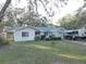 House with travel trailer in front and a small lawn at 4918 Woodland Dr, St Petersburg, FL 33708