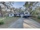 Home with travel trailer in driveway and landscaped front yard at 4918 Woodland Dr, St Petersburg, FL 33708
