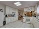 White kitchen cabinets, tile floors, and ample counter space at 4918 Woodland Dr, St Petersburg, FL 33708