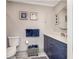 Bathroom with navy blue vanity and gray tile floors at 494 Boca Ciega Point N Blvd, St Petersburg, FL 33708