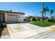 Exterior view showing a home's garage and neatly landscaped front yard at 494 Boca Ciega Point N Blvd, St Petersburg, FL 33708