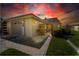 Home exterior at sunset showcasing landscaping and a two-car garage at 494 Boca Ciega Point N Blvd, St Petersburg, FL 33708