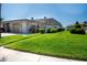 Well-maintained home exterior with a lush lawn and driveway at 494 Boca Ciega Point N Blvd, St Petersburg, FL 33708