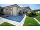 Inviting exterior featuring a paved walkway, attached garage, and well-manicured lawn at 494 Boca Ciega Point N Blvd, St Petersburg, FL 33708