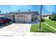 House exterior with two-car garage and landscaped yard at 494 Boca Ciega Point N Blvd, St Petersburg, FL 33708
