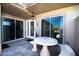 Stone patio with round table and bench seating near the home's entrance at 494 Boca Ciega Point N Blvd, St Petersburg, FL 33708