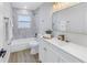 Clean bathroom with a bathtub, white vanity, and marble backsplash at 5718 Magnolia N St, St Petersburg, FL 33703